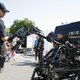 A police officer with a remote control is shown in front of a large robot.